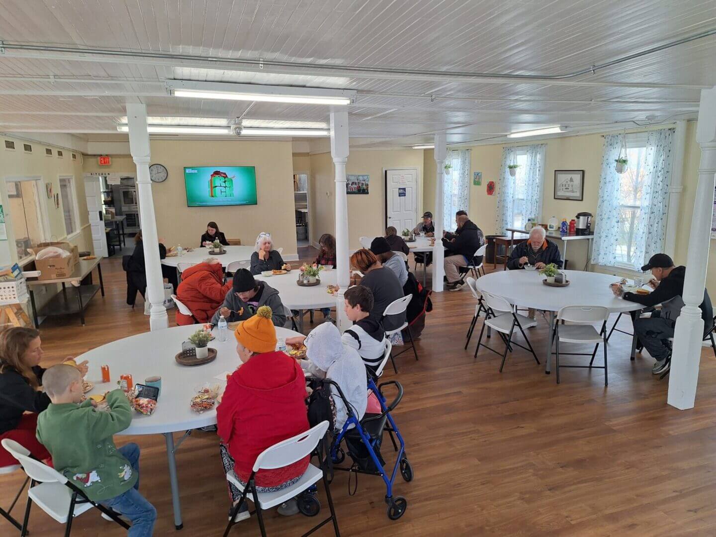 People dining in a community hall.